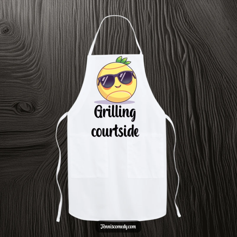 Funny apron showing a tennis ball in sunglasses chilling on a court, ideal for kitchen humor and as a unique gift.