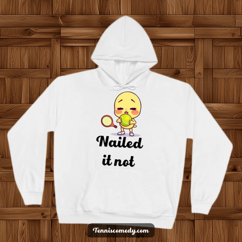 Funny hoodie featuring a character comically failing to serve a tennis ball with a funny face, ideal for comfort and as a gift.